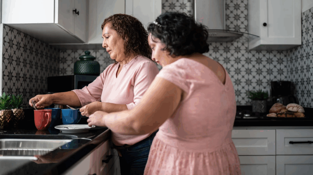 teen girl with Intellectual and Developmental Disabilities helping her caregiver in the kitchen a sign of improved social connections