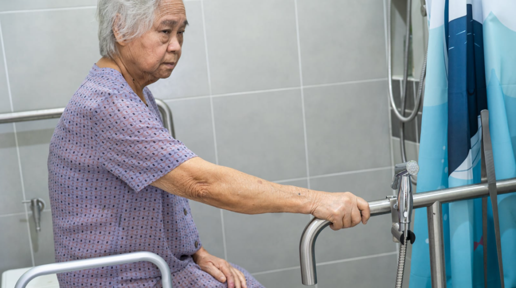 senior sitting on a toilet bowl